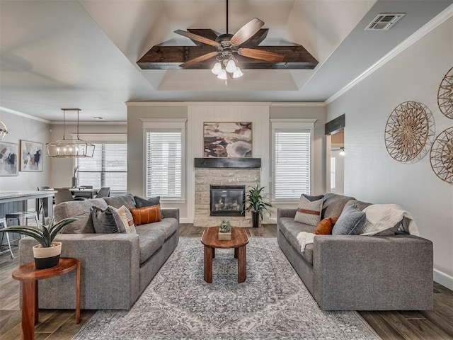 4821 Hidalgo Ave, Mustang, OK 73064 - living room featuring wood finished floors, a ceiling fan, ornamental molding, a raised ceiling, and a fireplace