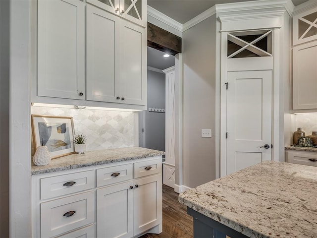 4821 Hidalgo Ave, Mustang, OK 73064 - kitchen with crown molding, dark wood-style floors, glass insert cabinets, decorative backsplash, and light stone counters
