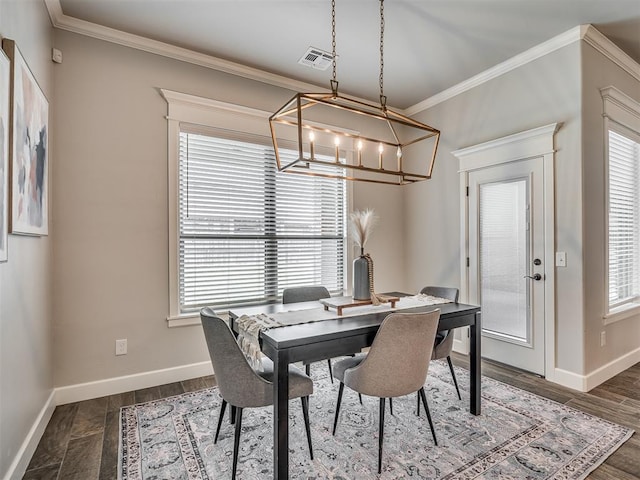 4821 Hidalgo Ave, Mustang, OK 73064 - dining area featuring a chandelier, healthy amount of natural light, crown molding, and dark wood finished floors
