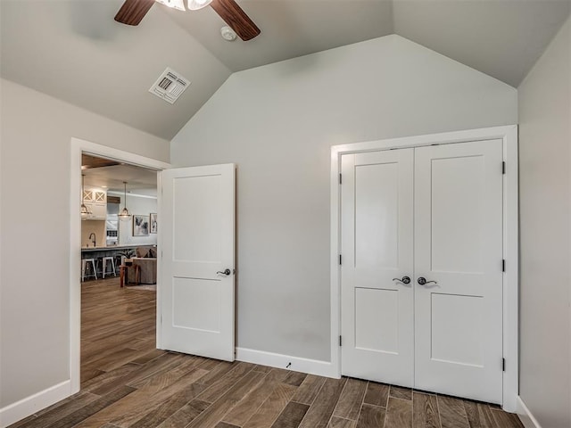 4821 Hidalgo Ave, Mustang, OK 73064 - unfurnished bedroom featuring lofted ceiling, wood finished floors, a closet, and a ceiling fan