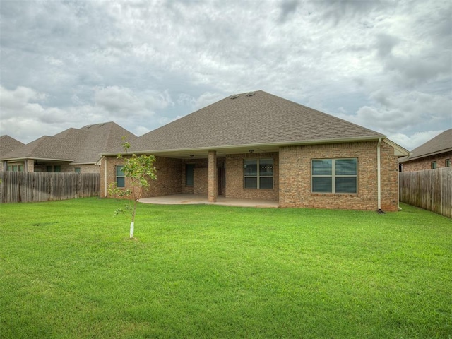 4821 Hidalgo Ave, Mustang, OK 73064 - rear view of property featuring roof with shingles, a fenced backyard, a patio area, and brick siding