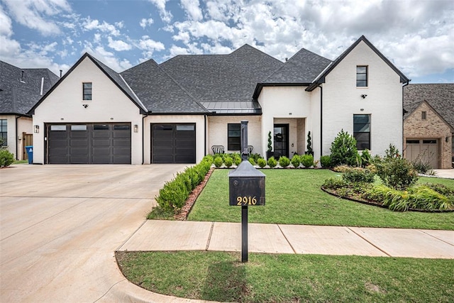 2916 Wood Thrush Way, Edmond, OK 73012 - french provincial home with concrete driveway, a front yard, a standing seam roof, a garage, and brick siding