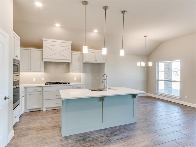 9313 NW 141st St, Yukon, OK 73099 - kitchen featuring appliances with stainless steel finishes, decorative backsplash, a chandelier, premium range hood, and lofted ceiling