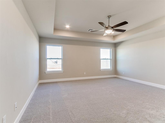 9313 NW 141st St, Yukon, OK 73099 - carpeted empty room with a tray ceiling and ceiling fan