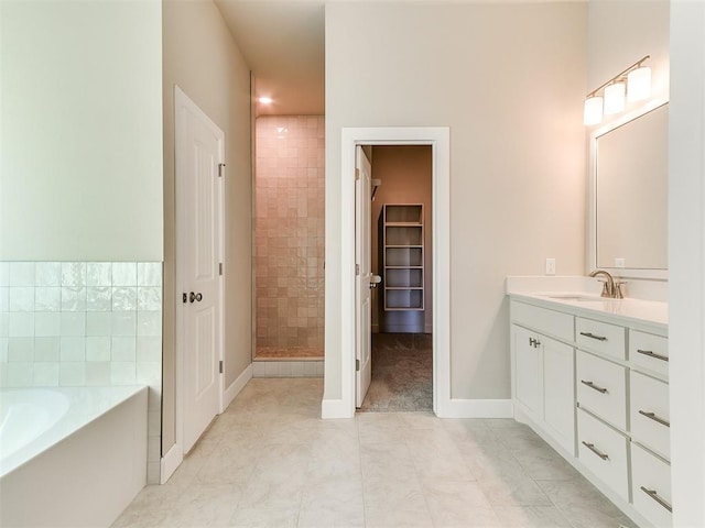 9313 NW 141st St, Yukon, OK 73099 - bathroom featuring vanity, a garden tub, tile patterned flooring, a tile shower, and a walk in closet