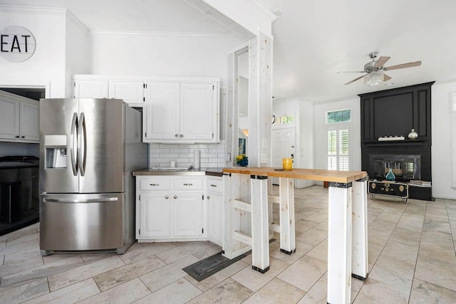 13848 Twin Ridge Dr, Edmond, OK 73034 - kitchen featuring stainless steel fridge with ice dispenser, ceiling fan, decorative backsplash, white cabinetry, and ornamental molding
