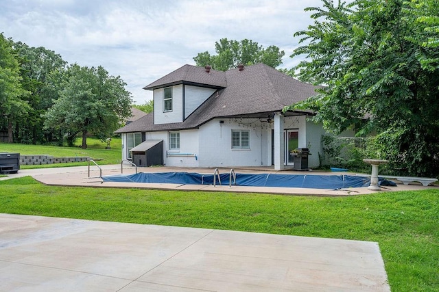 13848 Twin Ridge Dr, Edmond, OK 73034 - rear view of house featuring a covered pool, a yard, roof with shingles, and a patio area
