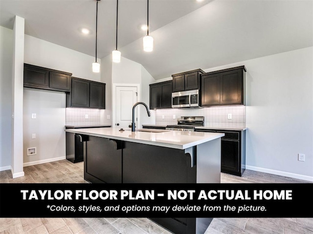 2508 Marsh Ln, Midwest City, OK 73130 - kitchen featuring appliances with stainless steel finishes, lofted ceiling, tasteful backsplash, light countertops, and an island with sink