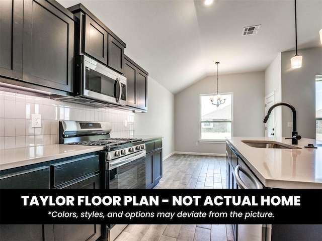 2508 Marsh Ln, Midwest City, OK 73130 - kitchen featuring stainless steel appliances, light wood-style floors, backsplash, vaulted ceiling, and light countertops