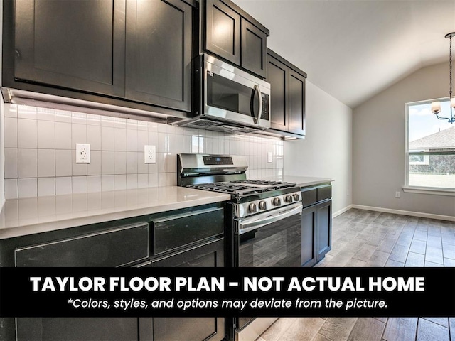 2508 Marsh Ln, Midwest City, OK 73130 - kitchen featuring stainless steel appliances, lofted ceiling, tasteful backsplash, light countertops, and decorative light fixtures