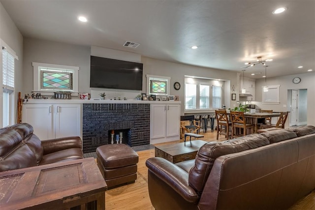 3424 NW 16th St, Oklahoma City, OK 73107 - living area with light wood-style floors, a brick fireplace, and recessed lighting