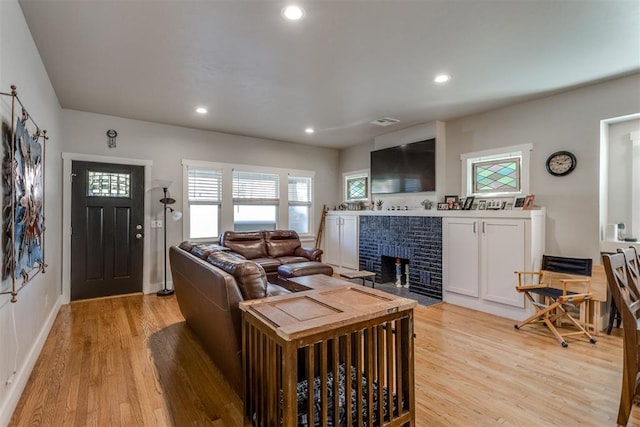 3424 NW 16th St, Oklahoma City, OK 73107 - living room with light wood finished floors, a tile fireplace, and recessed lighting