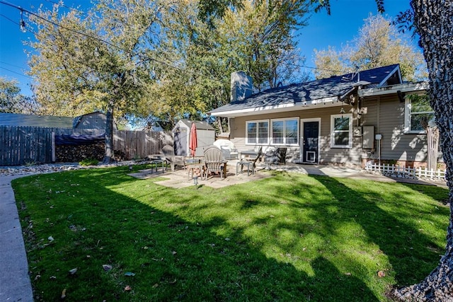 3424 NW 16th St, Oklahoma City, OK 73107 - back of property featuring a fenced backyard, a storage shed, and a patio