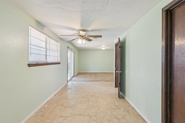 3513 Terry Way, Del City, OK 73115 - hallway with a textured ceiling and baseboards
