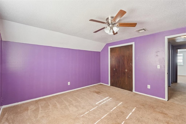 3513 Terry Way, Del City, OK 73115 - unfurnished bedroom featuring carpet flooring, a closet, vaulted ceiling, a textured ceiling, and ceiling fan