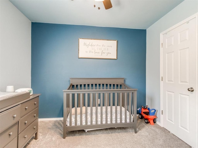 10408 NW 17th St, Oklahoma City, OK 73127 - bedroom with carpet flooring, a crib, and a ceiling fan