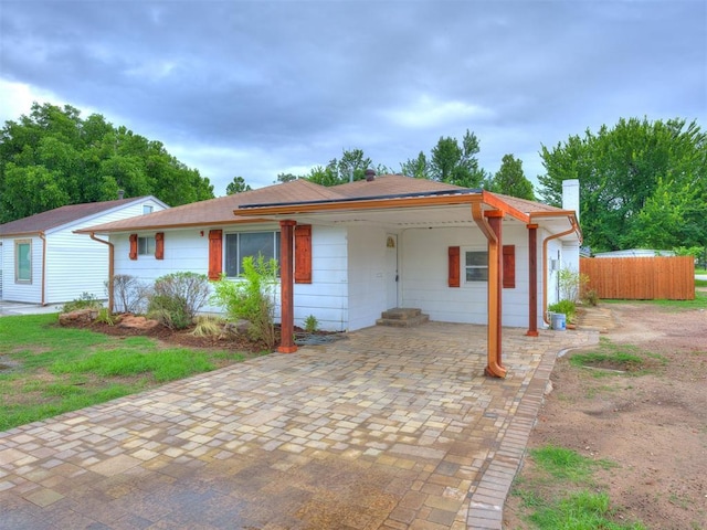 6908 NW 36th St, Bethany, OK 73008 - ranch-style house with an attached carport and a chimney