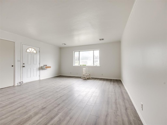 6908 NW 36th St, Bethany, OK 73008 - unfurnished living room featuring light wood-style flooring and baseboards