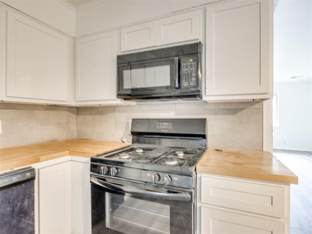 6908 NW 36th St, Bethany, OK 73008 - kitchen featuring black appliances, wood counters, ornamental molding, and white cabinets