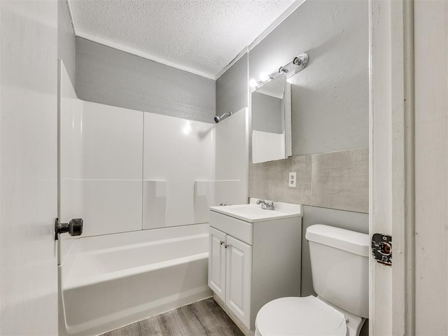6908 NW 36th St, Bethany, OK 73008 - bathroom with a textured ceiling, vanity, bathing tub / shower combination, and wood finished floors