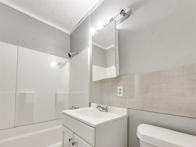 6908 NW 36th St, Bethany, OK 73008 - bathroom featuring bathing tub / shower combination, vanity, and a textured ceiling