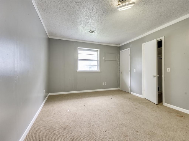 6908 NW 36th St, Bethany, OK 73008 - unfurnished bedroom featuring a textured ceiling, carpet, ornamental molding, and two closets