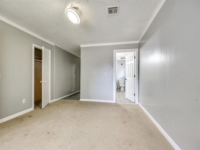 6908 NW 36th St, Bethany, OK 73008 - unfurnished bedroom with carpet, a textured ceiling, and ensuite bathroom