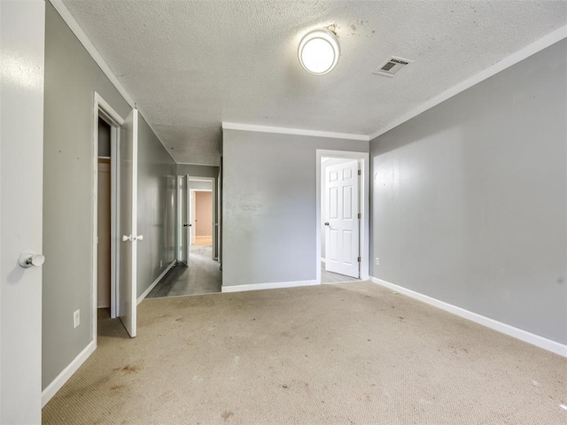6908 NW 36th St, Bethany, OK 73008 - empty room featuring a textured ceiling, carpet, and crown molding