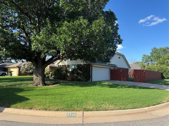 11700 Sierra Rd, Oklahoma City, OK 73162 - view of front facade with a garage, a gate, concrete driveway, and brick siding