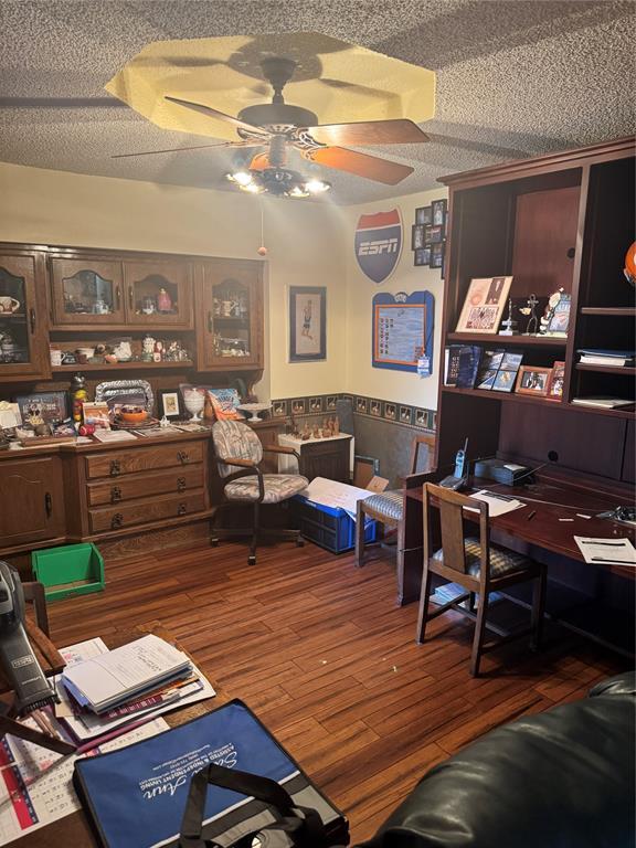 11700 Sierra Rd, Oklahoma City, OK 73162 - office area with a ceiling fan, wood finished floors, a wainscoted wall, and a textured ceiling