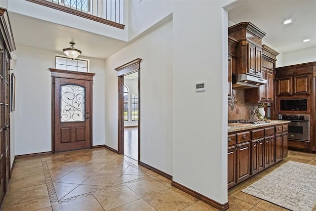 917 Erinova Dr, Yukon, OK 73099 - entryway with recessed lighting, inlaid floor details, and a towering ceiling