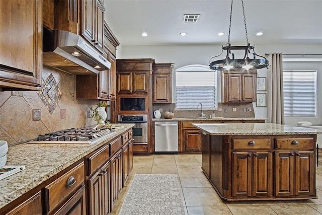 917 Erinova Dr, Yukon, OK 73099 - kitchen with stainless steel appliances, ventilation hood, decorative backsplash, recessed lighting, and light tile patterned flooring