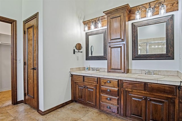 917 Erinova Dr, Yukon, OK 73099 - full bath featuring double vanity, a shower with door, and stone finish floors