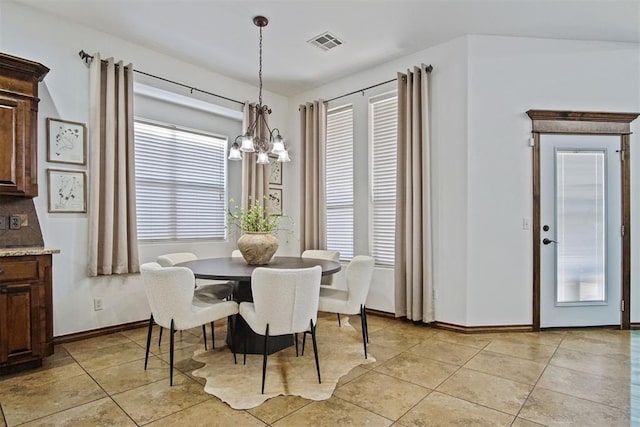 917 Erinova Dr, Yukon, OK 73099 - dining space with a chandelier, light tile patterned floors, and plenty of natural light