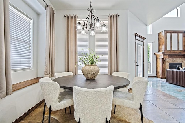 917 Erinova Dr, Yukon, OK 73099 - tiled dining room with a chandelier, plenty of natural light, and a fireplace