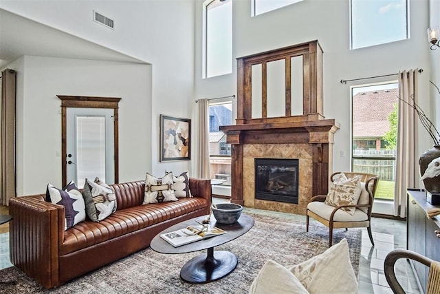 917 Erinova Dr, Yukon, OK 73099 - living room featuring a high ceiling, healthy amount of natural light, and a premium fireplace