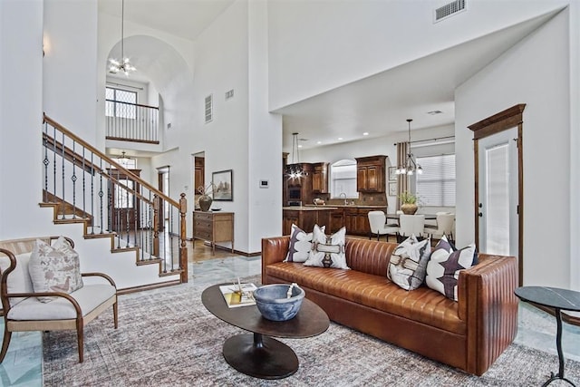 917 Erinova Dr, Yukon, OK 73099 - living room with a chandelier, a high ceiling, and stairs