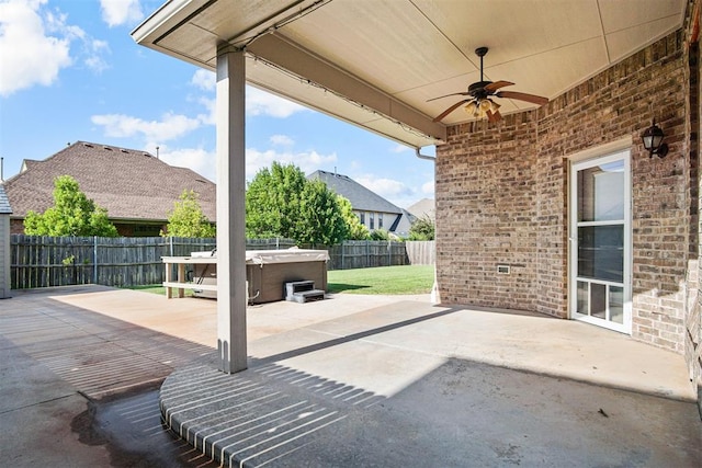 917 Erinova Dr, Yukon, OK 73099 - fenced backyard with a hot tub, a ceiling fan, and a patio area