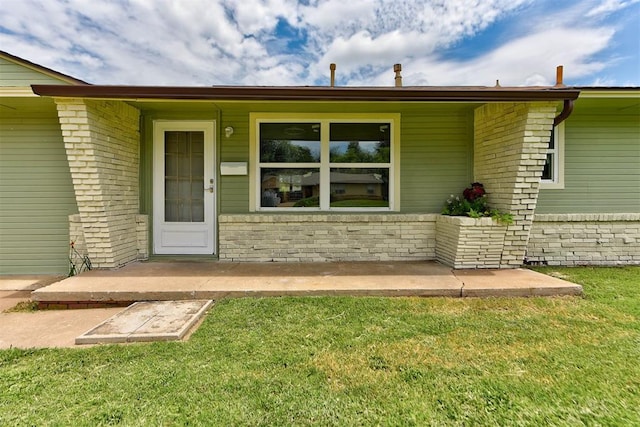 5417 NW 45th Ter, Warr Acres, OK 73122 - property entrance featuring a lawn and brick siding