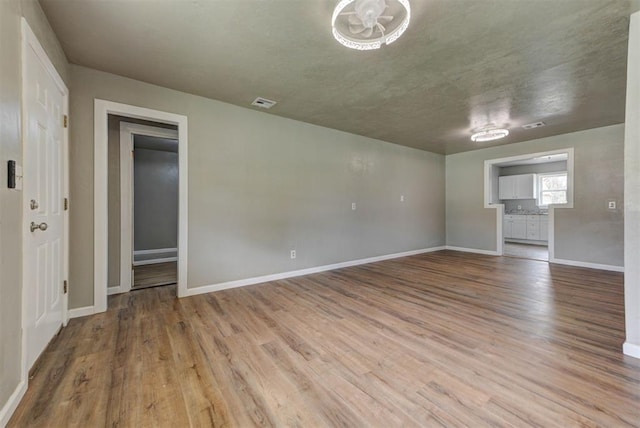5417 NW 45th Ter, Warr Acres, OK 73122 - unfurnished living room with wood finished floors and baseboards