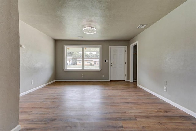 5417 NW 45th Ter, Warr Acres, OK 73122 - spare room with wood finished floors, a textured ceiling, and a textured wall