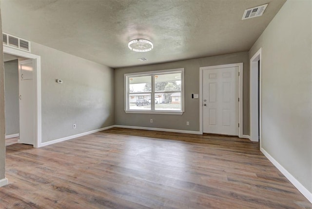 5417 NW 45th Ter, Warr Acres, OK 73122 - spare room with wood finished floors and a textured ceiling
