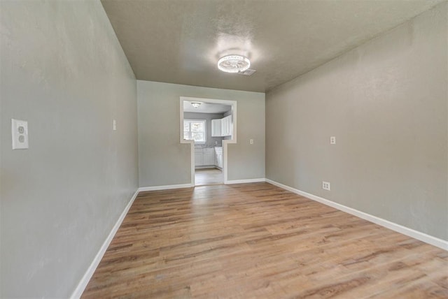 5417 NW 45th Ter, Warr Acres, OK 73122 - spare room featuring light wood-style floors and a textured ceiling