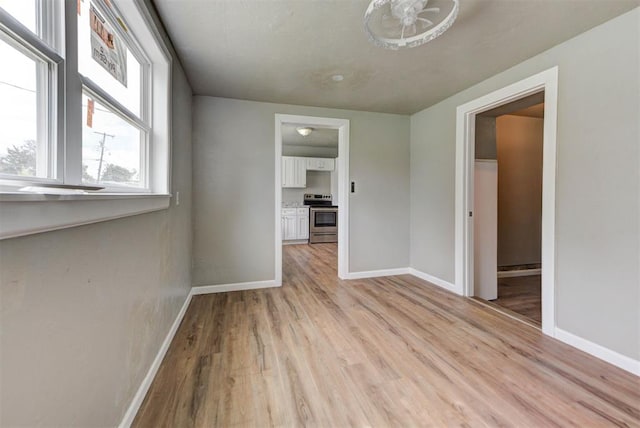 5417 NW 45th Ter, Warr Acres, OK 73122 - empty room with baseboards and light wood-type flooring