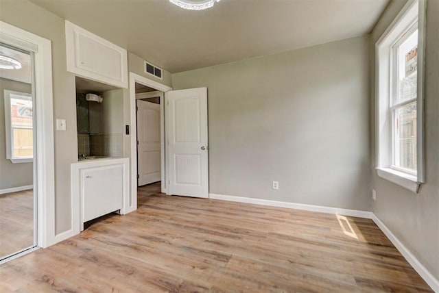 5417 NW 45th Ter, Warr Acres, OK 73122 - unfurnished bedroom featuring light wood-type flooring and baseboards