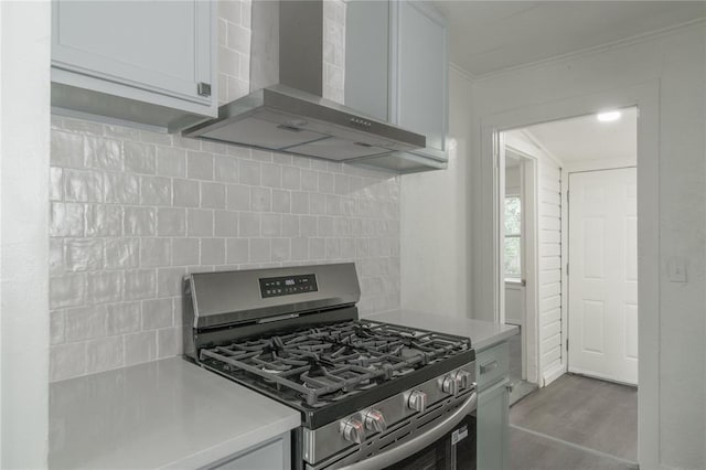 2220 SW 28th St, Oklahoma City, OK 73108 - kitchen featuring gas range, wall chimney range hood, light countertops, decorative backsplash, and crown molding