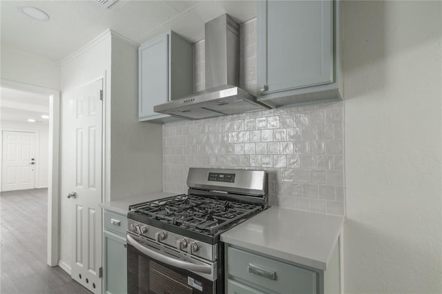 2220 SW 28th St, Oklahoma City, OK 73108 - kitchen featuring stainless steel gas range oven, wall chimney range hood, ornamental molding, light countertops, and backsplash