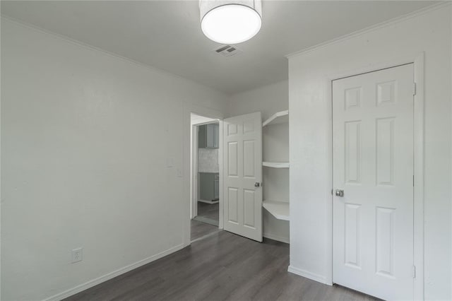 2220 SW 28th St, Oklahoma City, OK 73108 - unfurnished bedroom with dark wood finished floors and ornamental molding