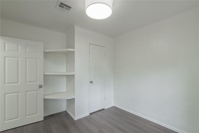 2220 SW 28th St, Oklahoma City, OK 73108 - unfurnished bedroom with ornamental molding, dark wood-type flooring, and a closet
