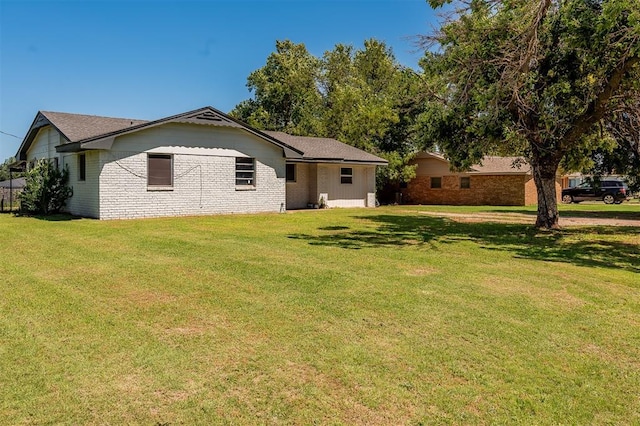 2120 E Robberts Ave, Kingfisher, OK 73750 - rear view of property with a lawn and brick siding